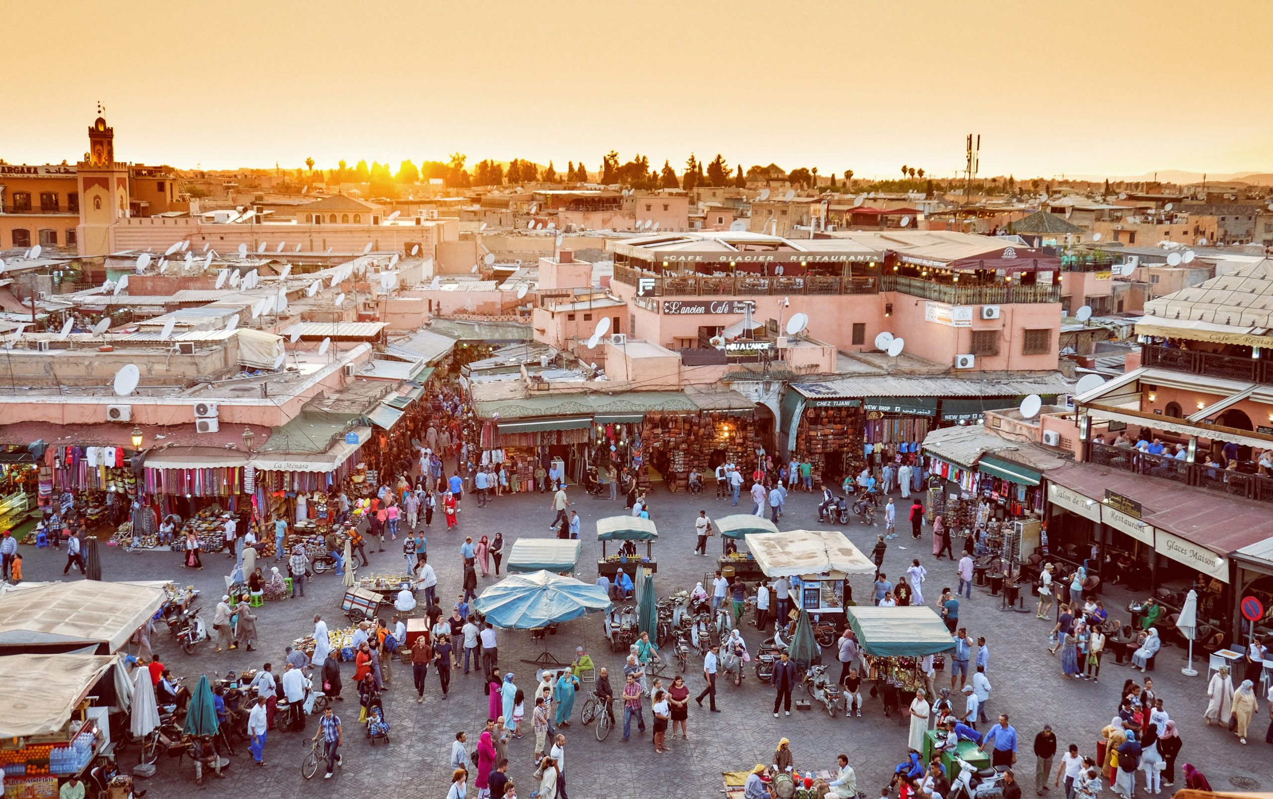 Local guide leading travelers through the historic streets of Marrakech Medina, Morocco.
